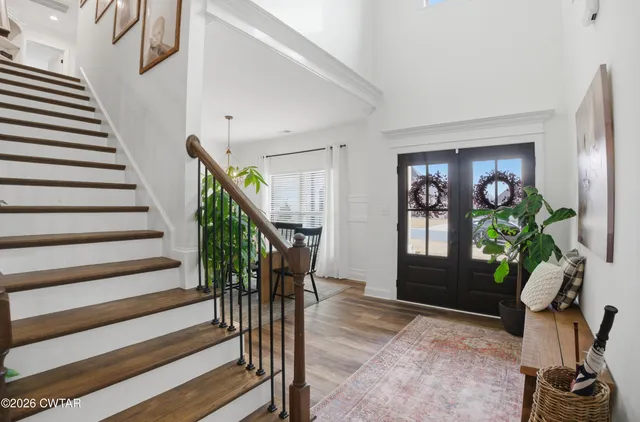 a view of entryway with wooden floor and stairs