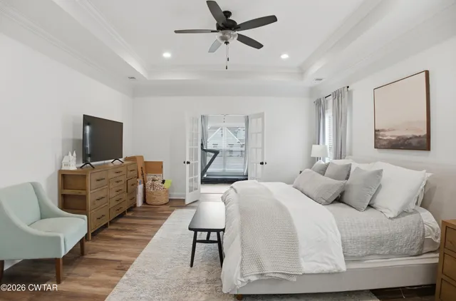 a bedroom with furniture and a flat screen tv