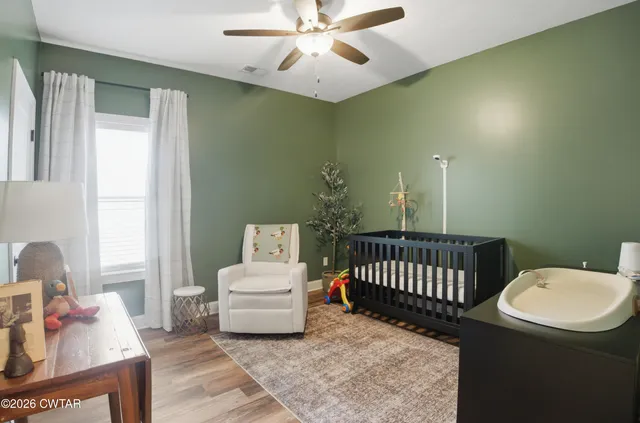 a bedroom with furniture and a window