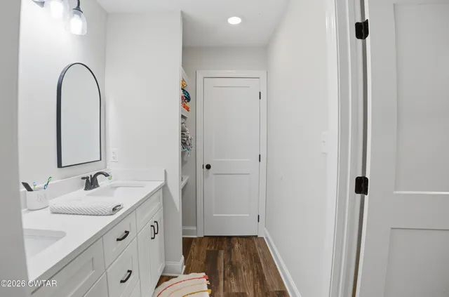 a spacious bathroom with a sink and a mirror