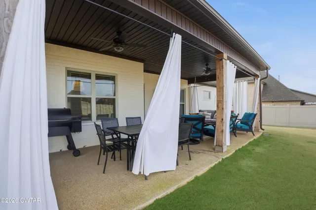 a view of a house with backyard porch and sitting area