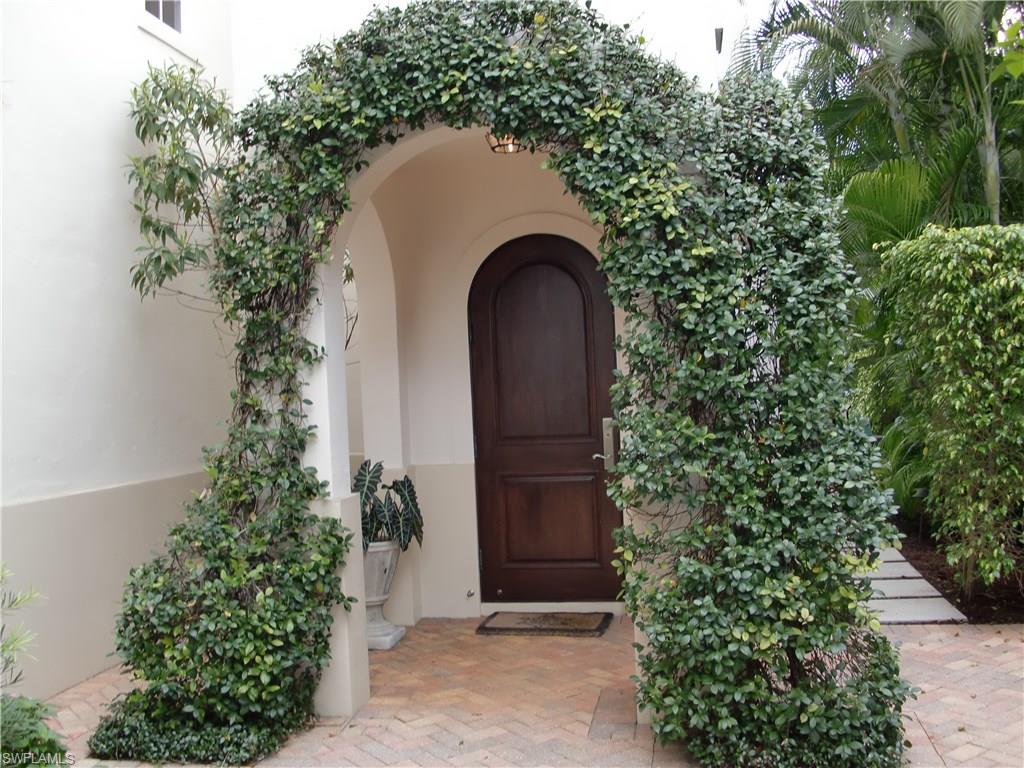 435 3rd Avenue South, Unit 3 Naples, FL 34102 - Photo 1 of 12 a couple of potted plants in front of a door