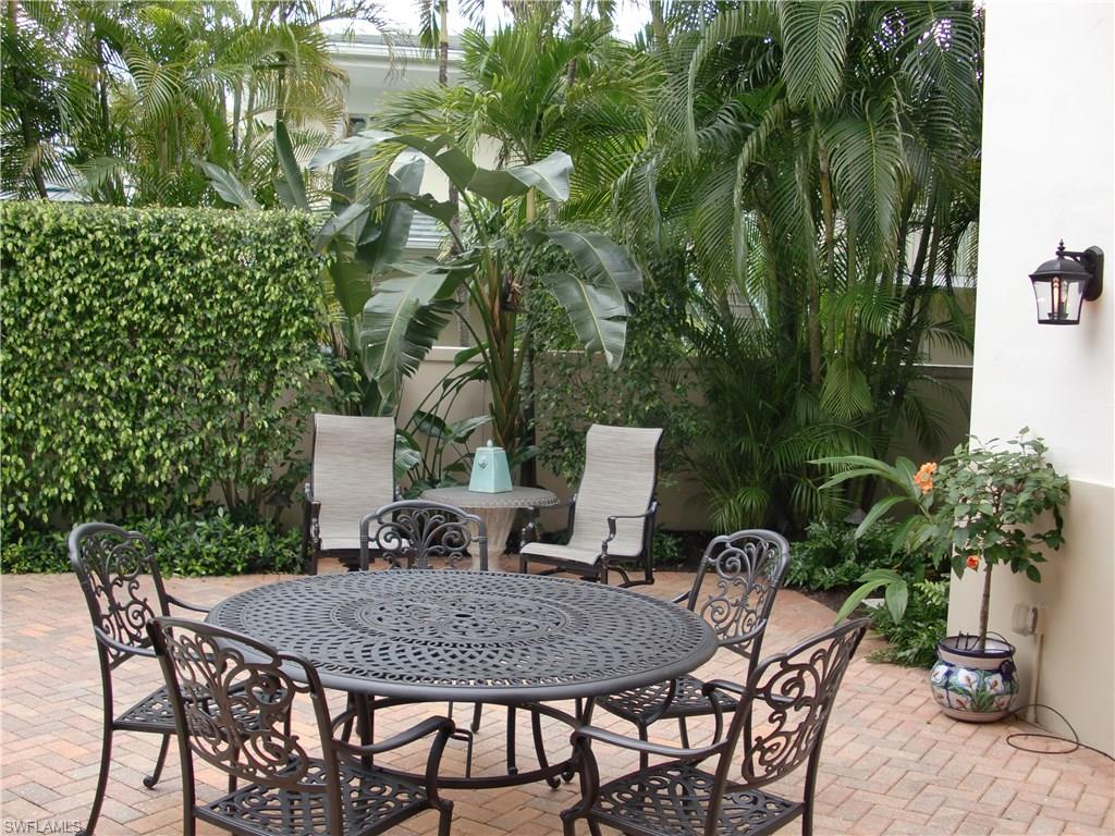 435 3rd Avenue South, Unit 3 Naples, FL 34102 - Photo 11 of 12 a view of a backyard with furniture and a garden