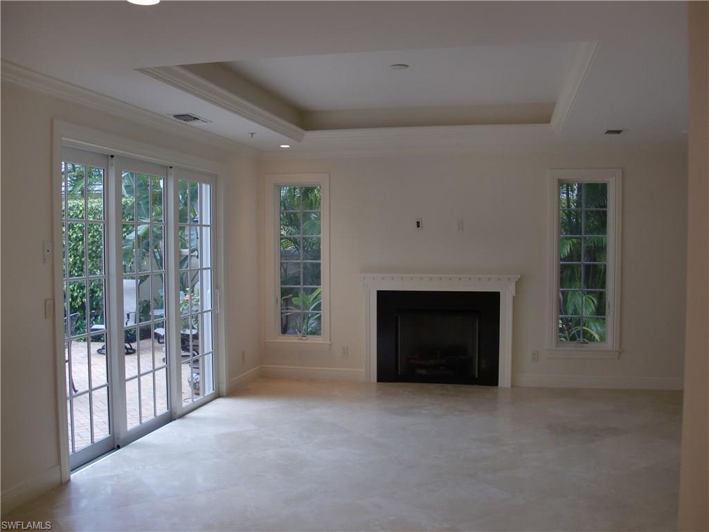 435 3rd Avenue South, Unit 3 Naples, FL 34102 - Photo 3 of 12 a view of a livingroom with a fireplace and window
