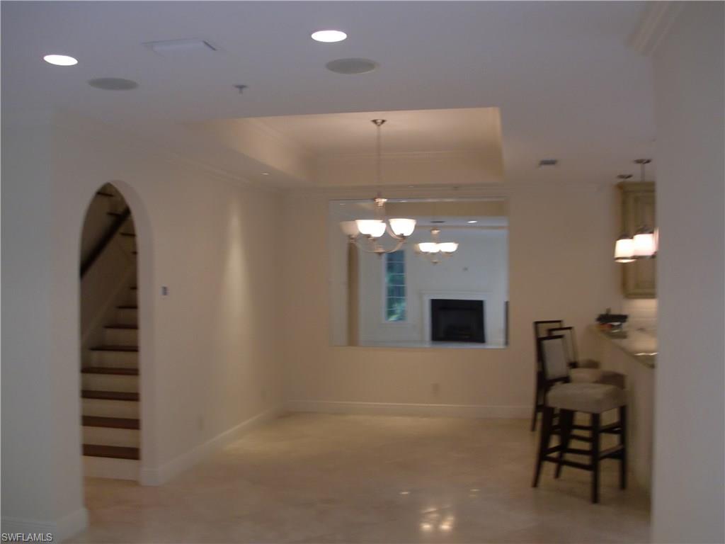 435 3rd Avenue South, Unit 3 Naples, FL 34102 - Photo 4 of 12 a view of a livingroom with furniture and staircase