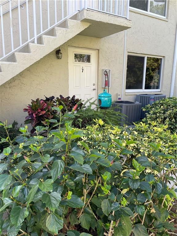 200 Palm Drive, Unit 7 Naples, FL 34112 - Photo 14 of 21 a front view of a house with a yard