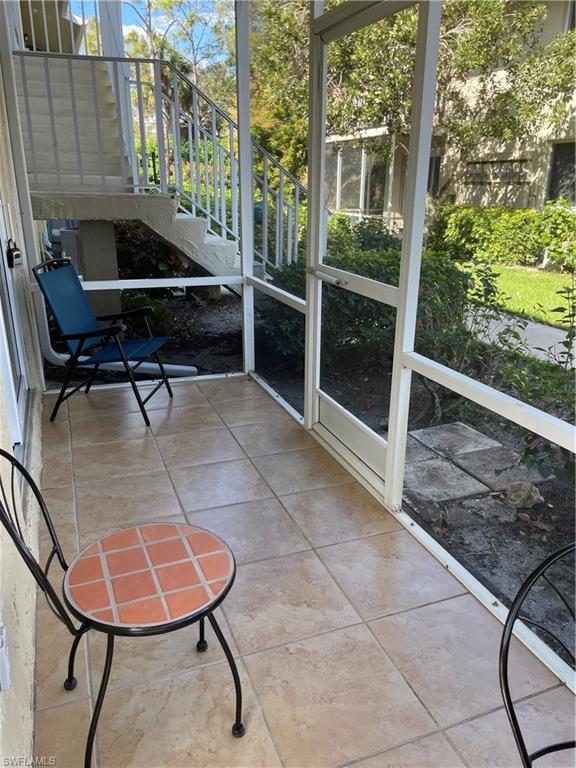 200 Palm Drive, Unit 7 Naples, FL 34112 - Photo 17 of 21 a backyard of a house with table and chairs