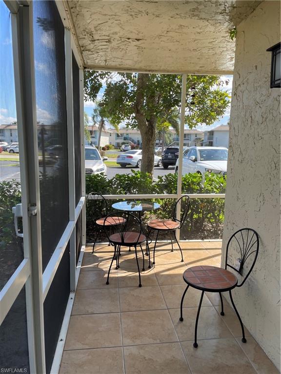 200 Palm Drive, Unit 7 Naples, FL 34112 - Photo 18 of 21 a view of a chairs and table in the balcony