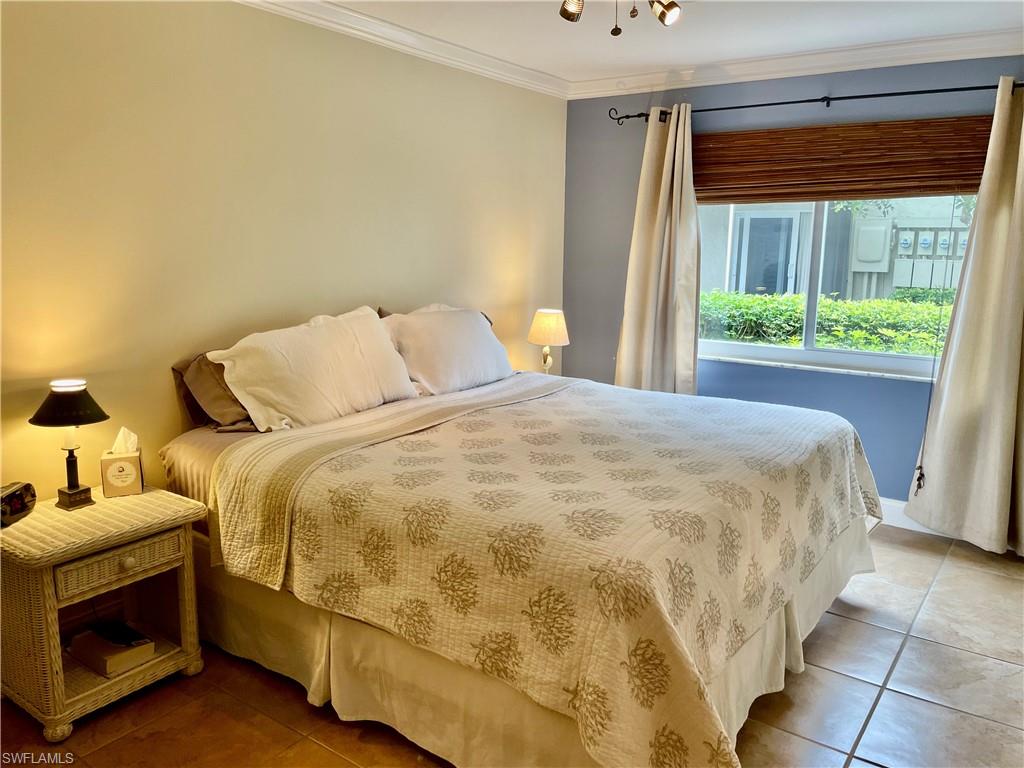 200 Palm Drive, Unit 7 Naples, FL 34112 - Photo 6 of 21 a bedroom with a bed and a window