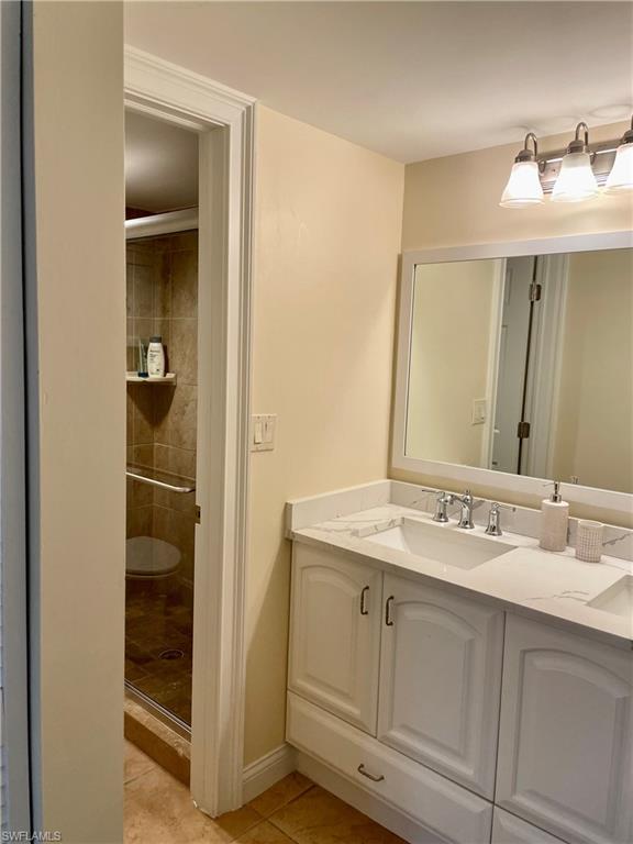 200 Palm Drive, Unit 7 Naples, FL 34112 - Photo 7 of 21 a bathroom with a sink and a mirror