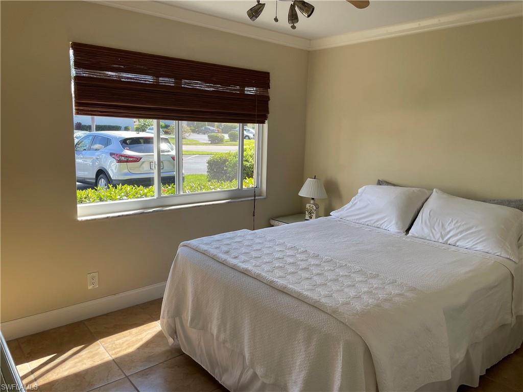 200 Palm Drive, Unit 7 Naples, FL 34112 - Photo 10 of 21 a bedroom with a bed and a window