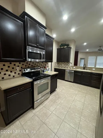 a kitchen with stainless steel appliances granite countertop a sink and stove