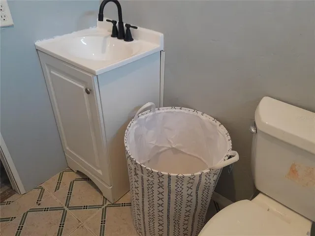 a bathroom with a sink toilet and mirror