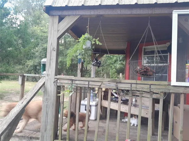 a view of a balcony with wooden floor and outdoor seating