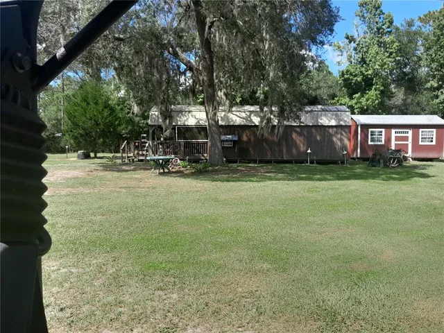 a view of a patio with table and chairs and potted plants