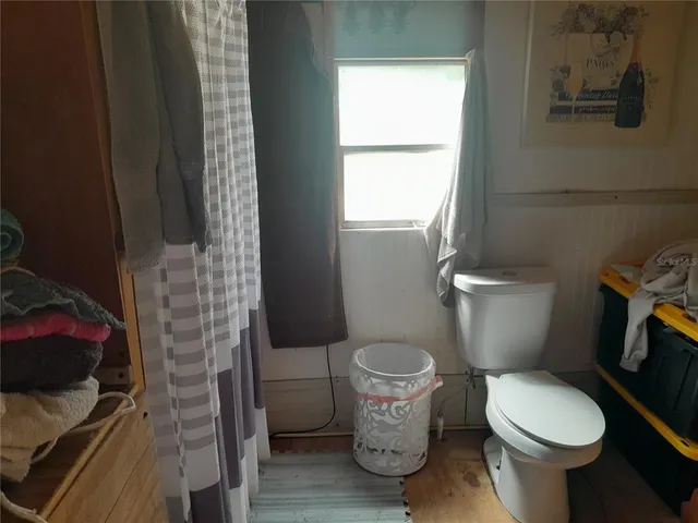 a white toilet sitting next to a window