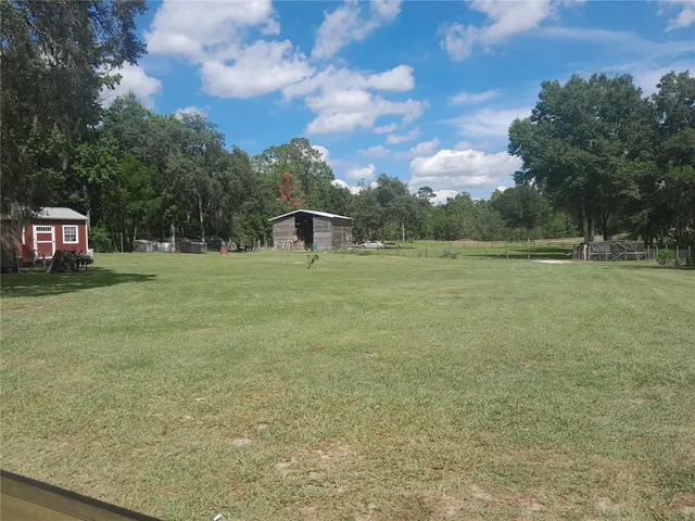 a backyard of a house with lots of green space