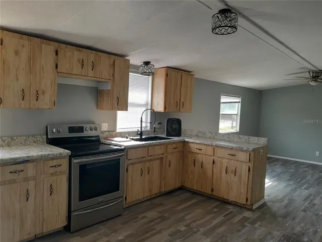 a kitchen with stainless steel appliances granite countertop a stove and a sink