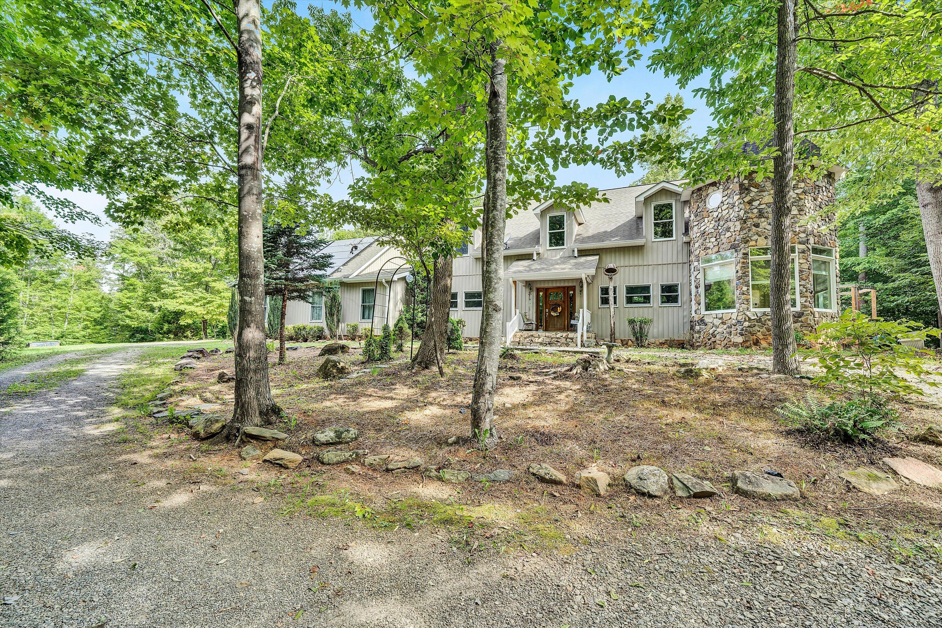 front view of a house with a tree