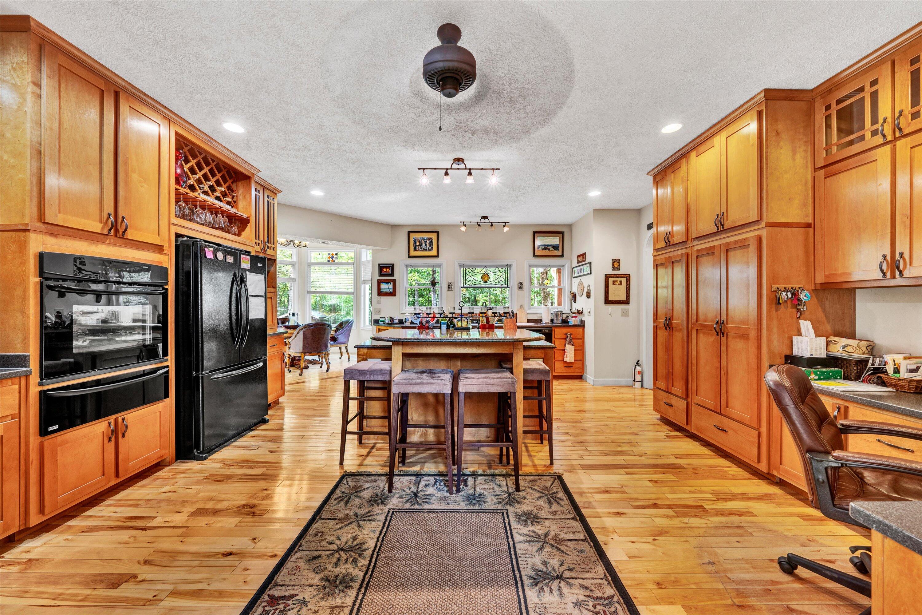 11289 Sontag Road Martinsville, VA 24112 - Photo 15 of 55 a living room with stainless steel appliances kitchen island granite countertop furniture a rug and a kitchen view