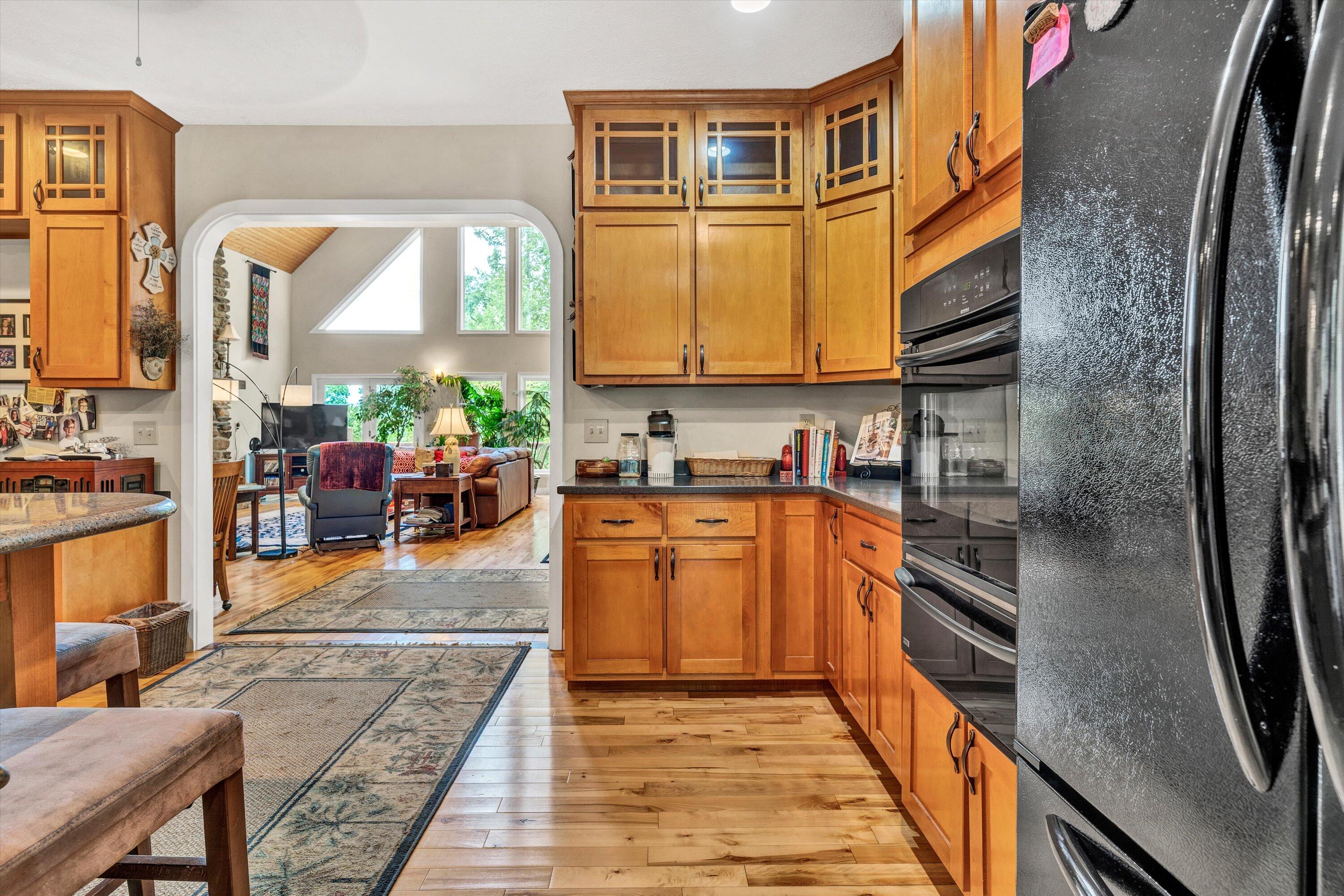 11289 Sontag Road Martinsville, VA 24112 - Photo 26 of 55 a kitchen with stainless steel appliances granite countertop a refrigerator a stove and a sink with wooden cabinets
