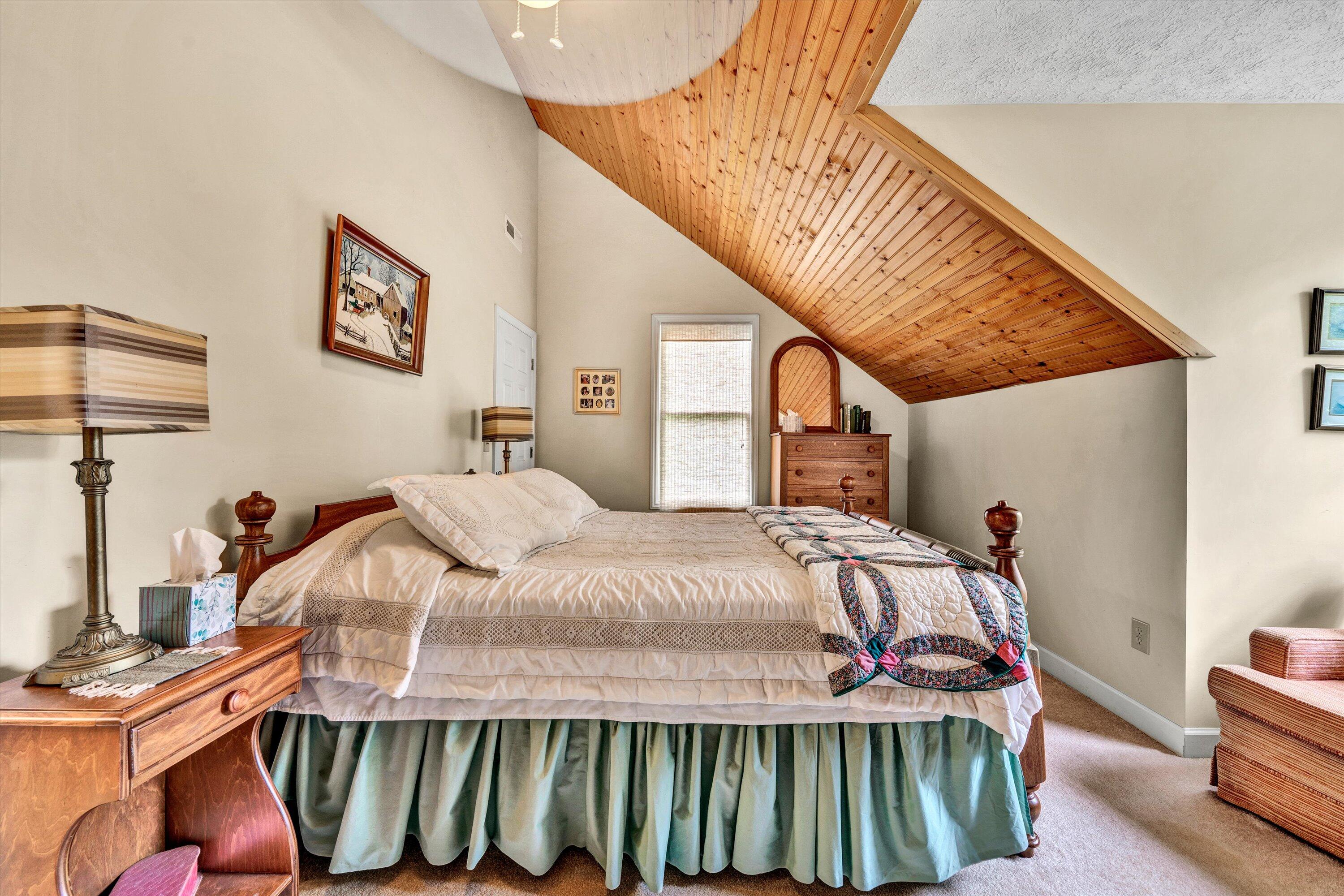 11289 Sontag Road Martinsville, VA 24112 - Photo 48 of 55 a bedroom with a bed and a chandelier