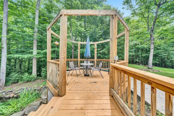 a view of a house with backyard porch and sitting area