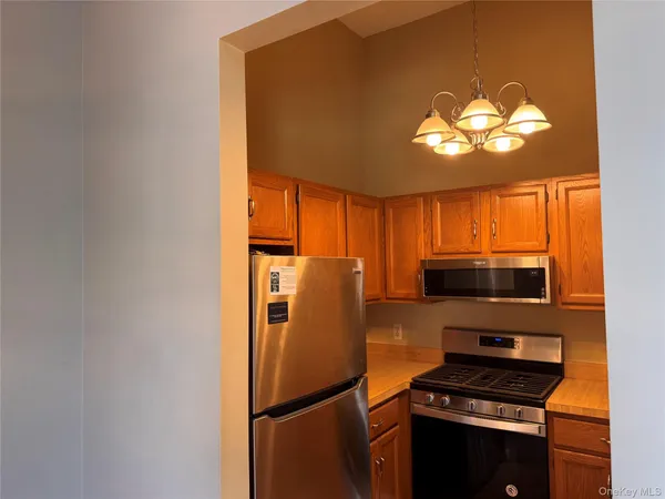 a kitchen with stainless steel appliances a refrigerator and a stove top oven