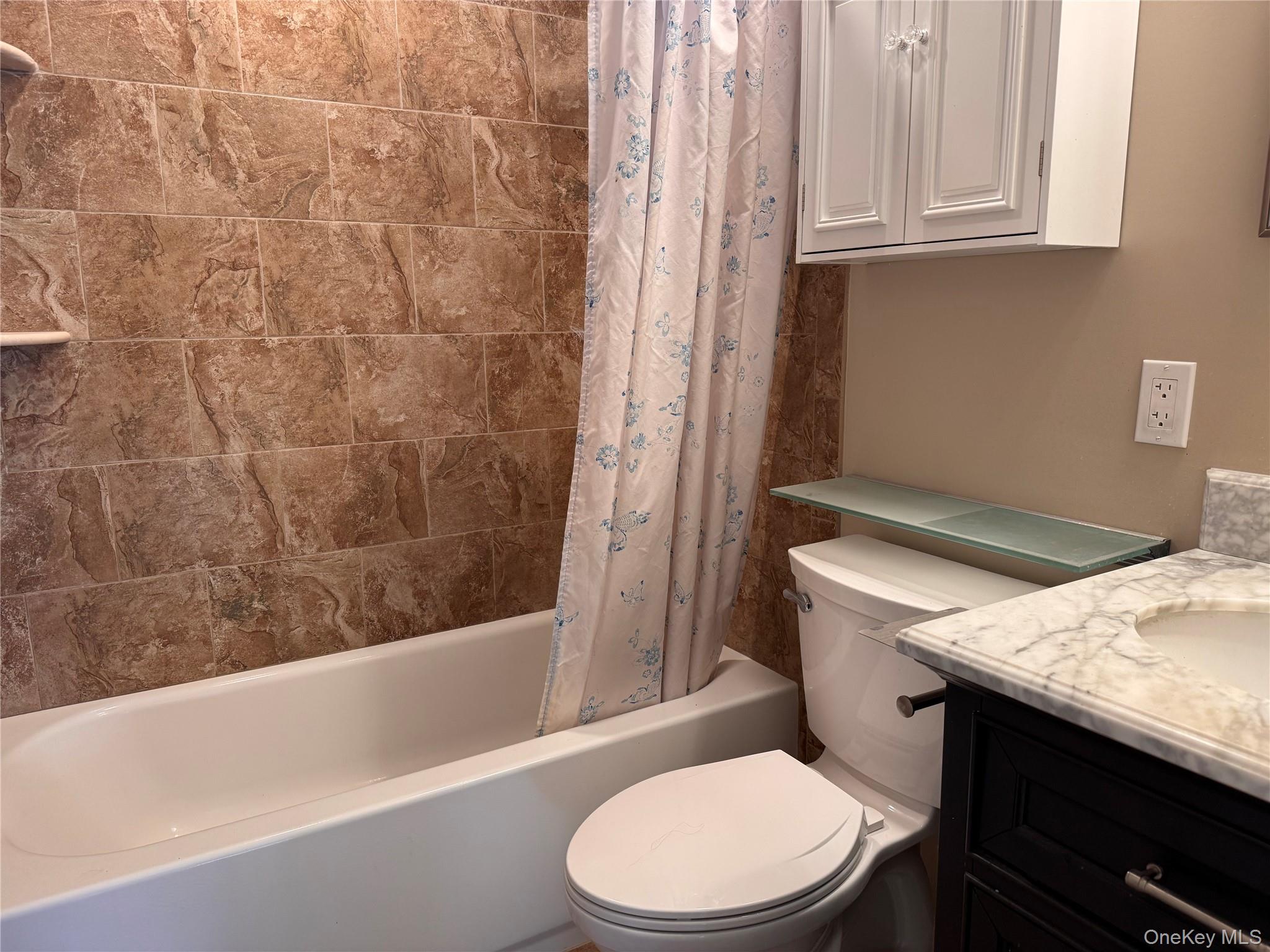 4 Lexington Hills Road, Unit 6 Harriman, NY 10926 - Photo 13 of 19 a white toilet sitting next to a bath tub