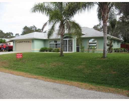 5875 Elton Road Venice, FL 34293 - Photo 1 of 1 a front view of a house with a garden and trees
