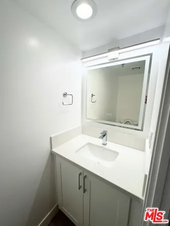 a bathroom with a sink and mirror