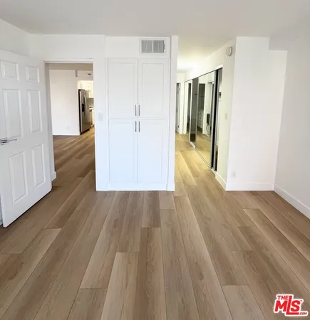 a view of hallway with wooden floor