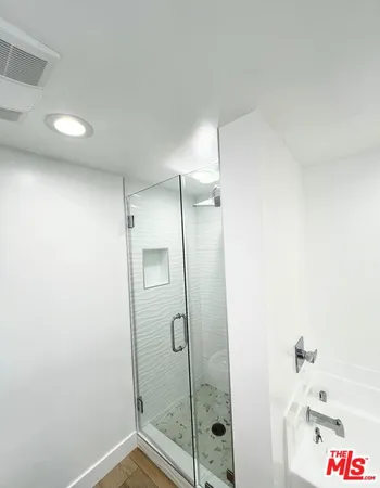 a bathroom with a shower and a sink