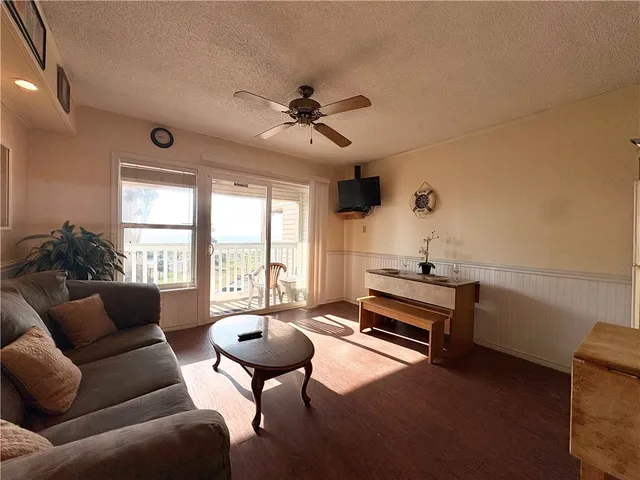 a living room with furniture a table and a large window