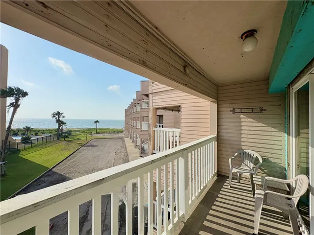 a view of a balcony and yard