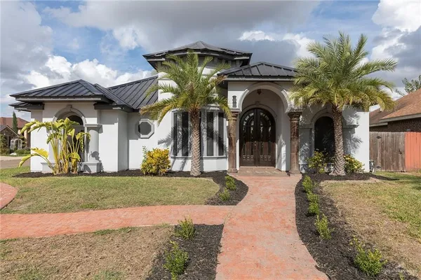 a front view of a house with garden
