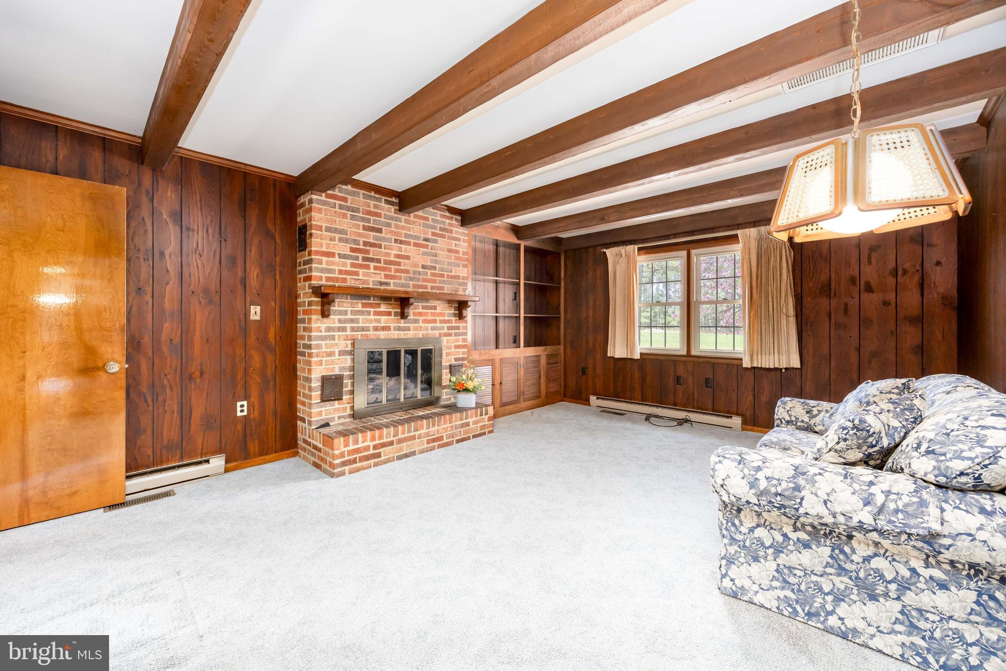36479 Purnell Crossing Road Willards, MD 21874 - Photo 21 of 65 a view of an empty room with a fireplace and a window