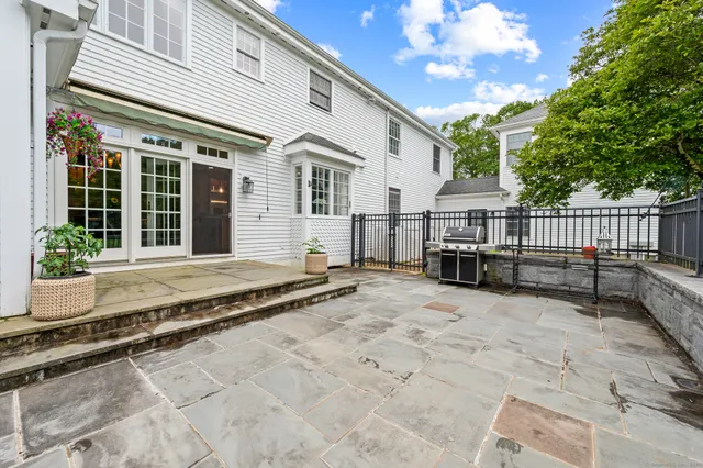 a view of a house with a wooden fence