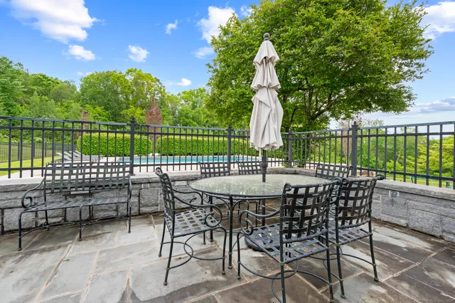 a view of a patio with a table and chairs