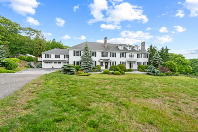 a front view of a house with a yard table and chairs