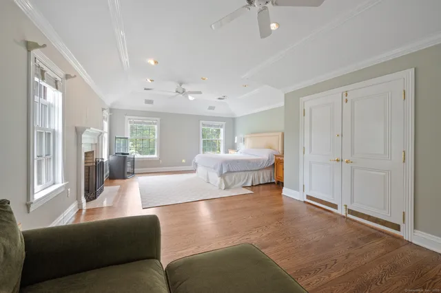 a bathroom with a granite countertop sink a toilet a mirror and shower