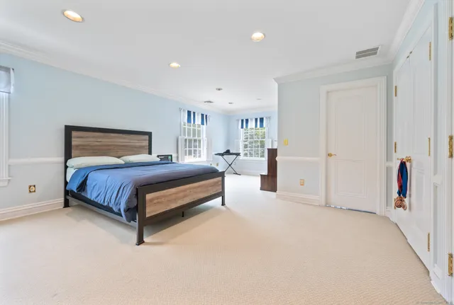 a bedroom with a large bed and a couch