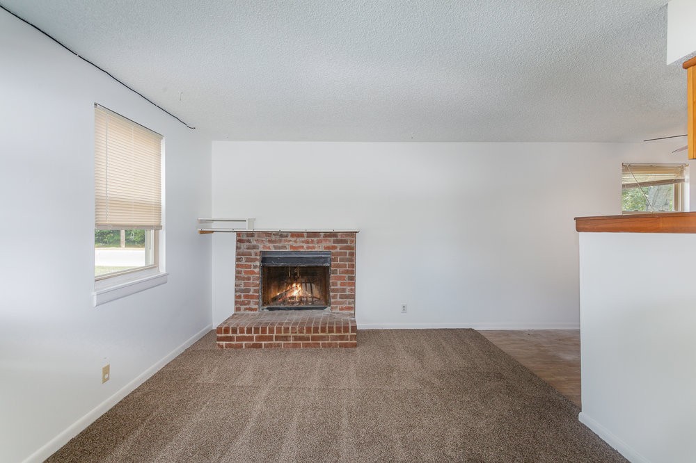 4357 Central Valley Drive Hermitage, TN 37076 - Photo 7 of 19 an empty room with a fireplace and windows
