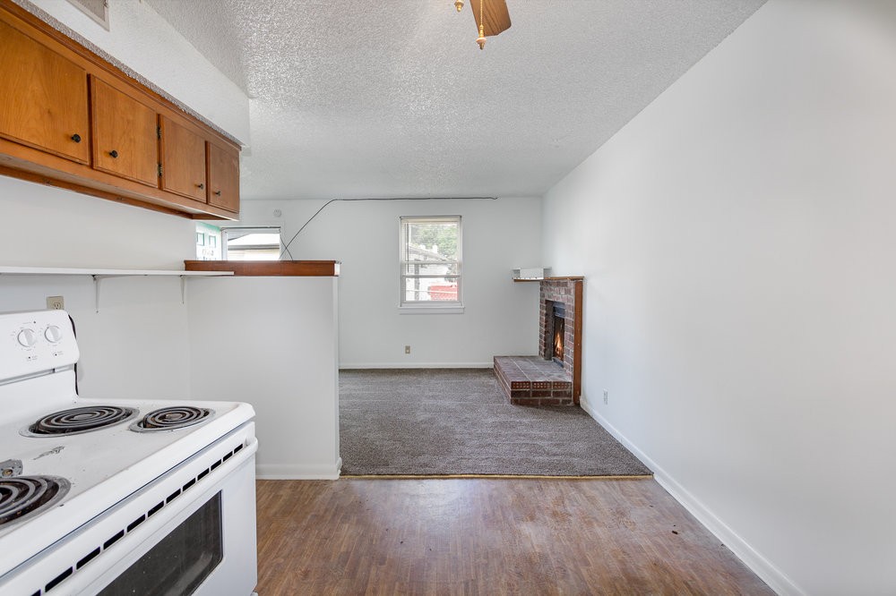 4357 Central Valley Drive Hermitage, TN 37076 - Photo 10 of 19 a kitchen with granite countertop a stove and a wooden floor