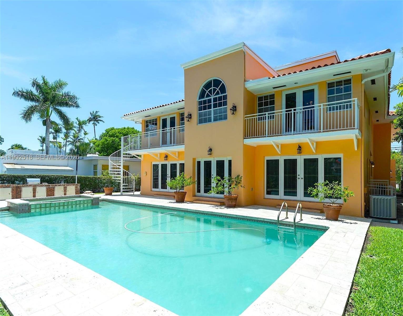 5309 Alton Road Miami Beach, FL 33140 - Photo 1 of 51 a front view of a house with swimming pool having outdoor seating