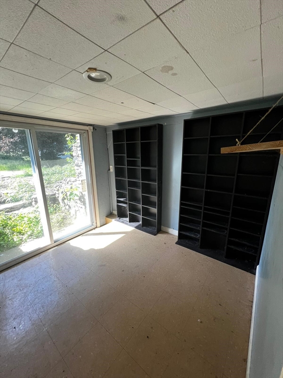16 Grist Mill Road Grafton, MA 01519 - Photo 11 of 16 a view of an empty room with a window and brick walls