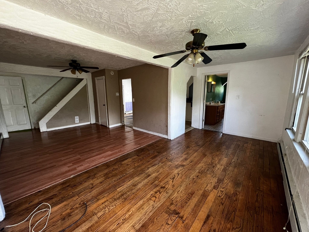 16 Grist Mill Road Grafton, MA 01519 - Photo 2 of 16 a view of a hallway view with wooden floor and staircase