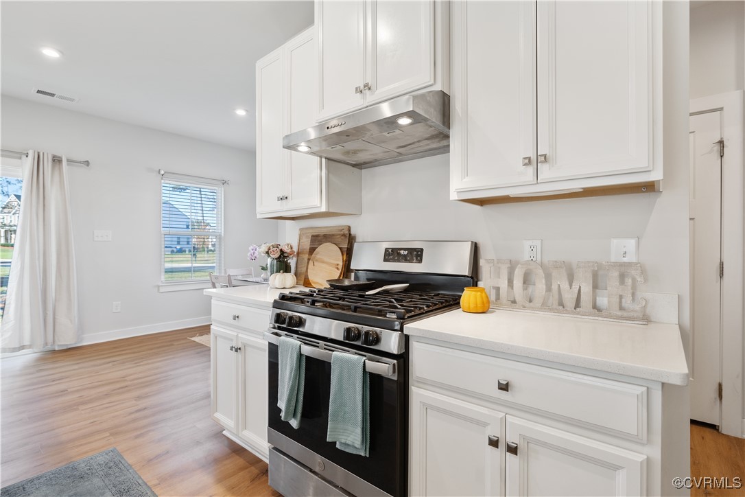 13901 Marsham Road Chester, VA 23836 - Photo 11 of 27 a kitchen with white cabinets and appliances