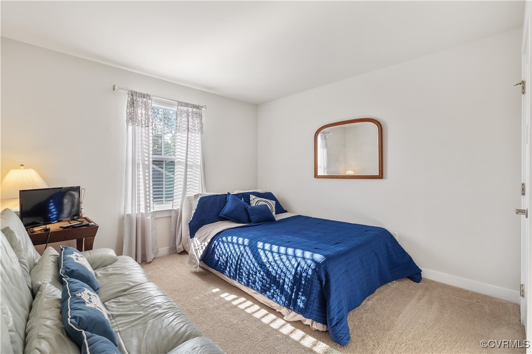 13901 Marsham Road Chester, VA 23836 - Photo 16 of 27 a bedroom with a bed and wooden floor