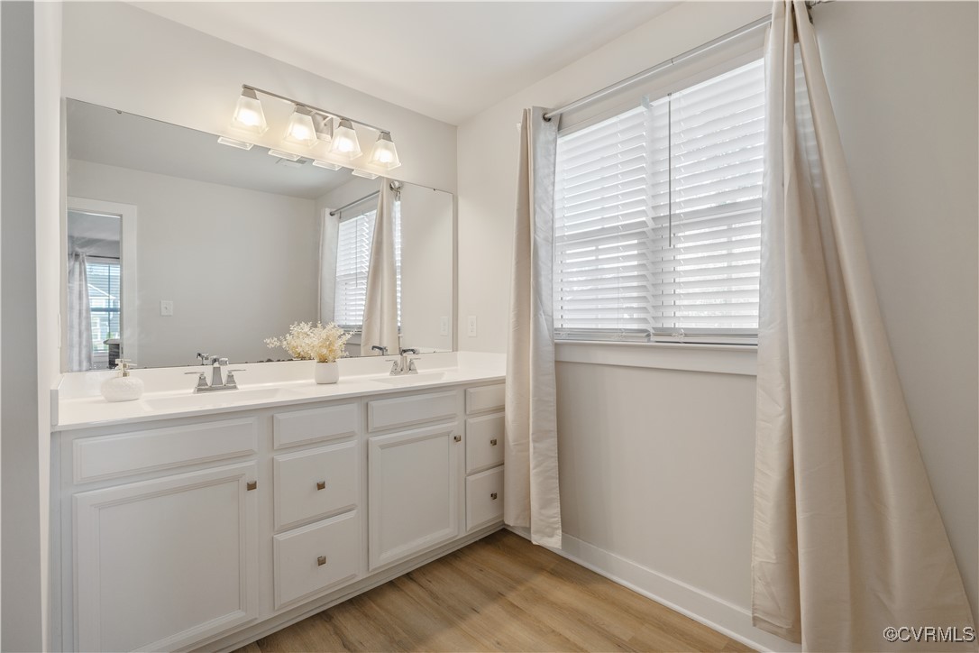 13901 Marsham Road Chester, VA 23836 - Photo 22 of 27 a bathroom with a double vanity sink and a mirror